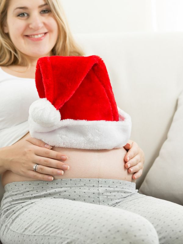 Pregnancy announcement with a Santa hat