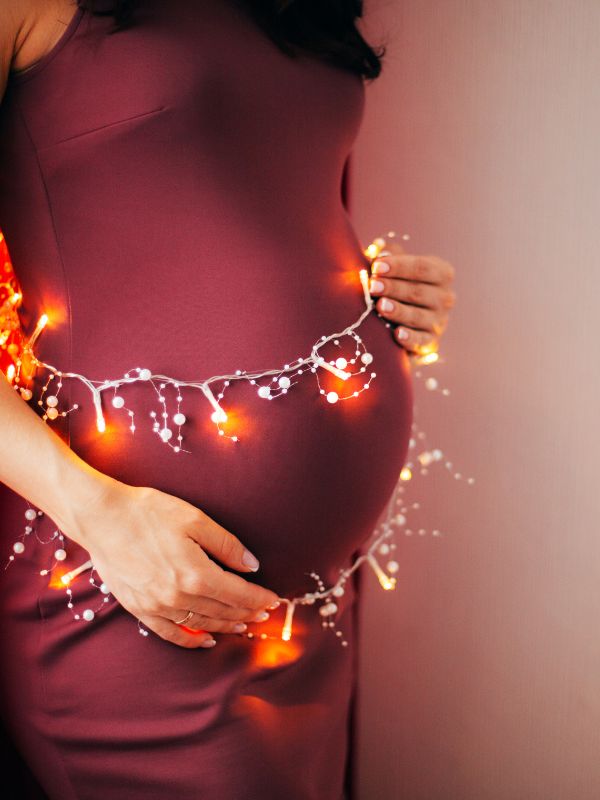 Christmas pregnancy announcement with twinkle lights