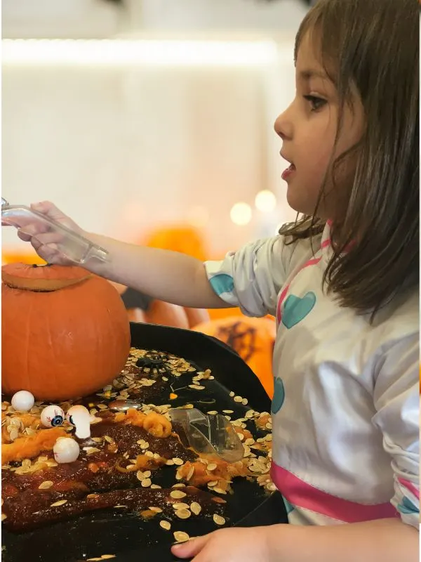 baby decorating a pumpkin