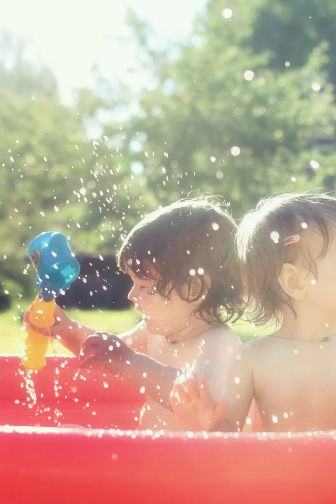 babies having fun in the summer in a paddling pool