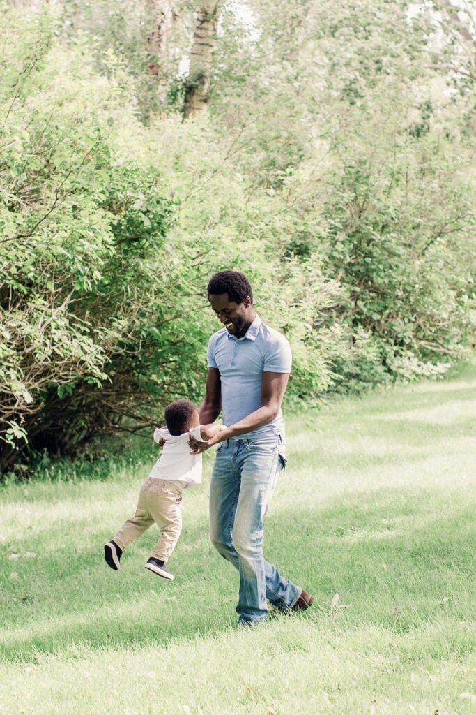 father and son playing in the park