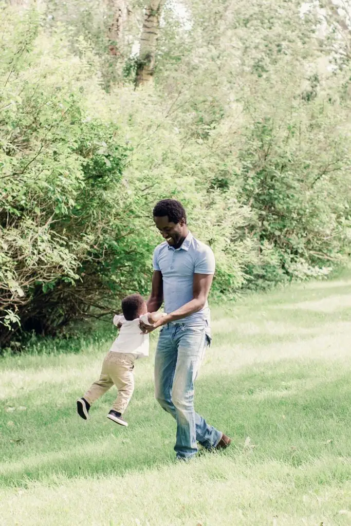 father and son playing in the park